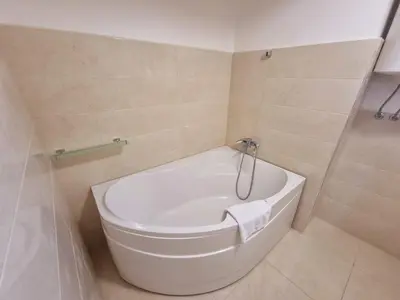 a bathroom with a white toilet in a room at Harmonia Budva 1 in Budva