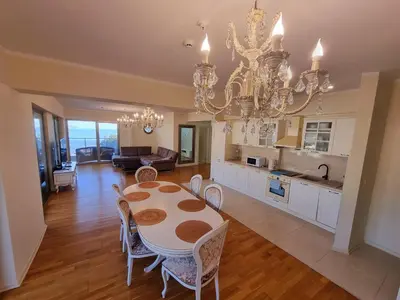 a dining room and kitchen with a chandelier at Harmonia Budva 1 in Budva