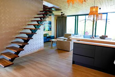 a spiral staircase in a living room with a couch at Amazonas Pirates 4 in Gornji Štoj