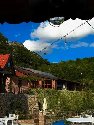 a couple of lights hanging over a pool in front of a building at Peuta Hill in Stara Zlatica