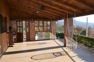 a patio with two chairs and glass doors on a building at Peuta Hill in Stara Zlatica