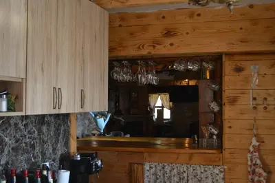a kitchen with wooden cabinets and glasses on the counter at Peuta Hill in Stara Zlatica