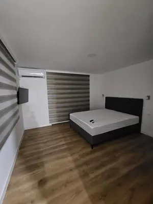 a bedroom with a bed and a wooden floor at Apartment Anita Cetinje in Cetinje
