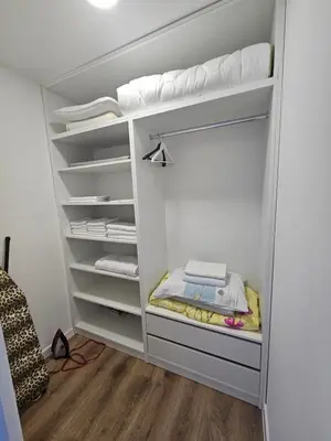 a walk in closet with white walls and white shelves at Apartment Anita Cetinje in Cetinje