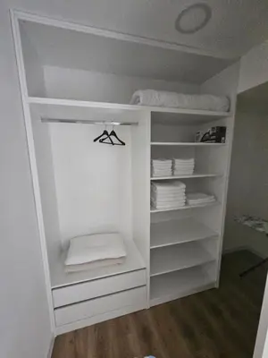 a white closet with white shelves and towels at Apartment Anita Cetinje 2 in Cetinje