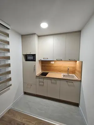 a kitchen with white cabinets and a sink at Apartment Anita Cetinje 2 in Cetinje