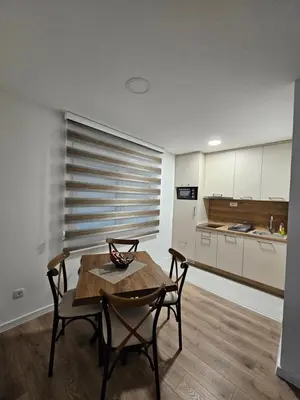a kitchen with a table and chairs in a room at Apartment Anita Cetinje 2 in Cetinje