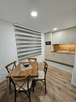 a kitchen and dining room with a wooden table and chairs at Apartment Anita Cetinje 2 in Cetinje
