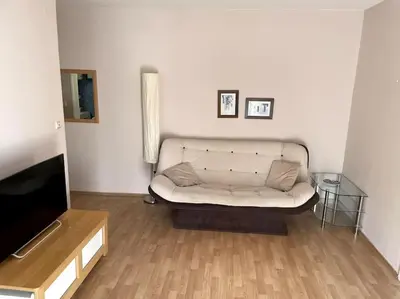 a living room with a white couch and a television at Magnolia Apartment in Budva