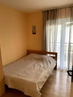 a bedroom with a bed and a large window at Magnolia Apartment in Budva