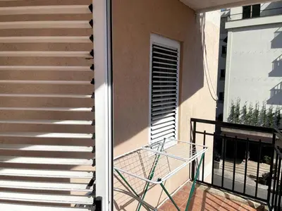 a staircase with a glass railing on a balcony at Magnolia Apartment in Budva