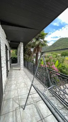 a porch of a house with a fence at Happy Home in Lastva