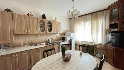 a kitchen with a table with chairs and a dining room at Happy Home in Lastva
