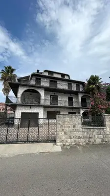 a building with a fence in front of it at Happy Home in Lastva