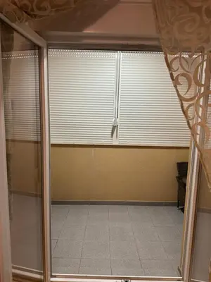 an empty room with a window with blinds at Viktor Apartman in Podgorica