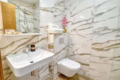 a bathroom with a white sink and a toilet at Ivanovic residences in Budva