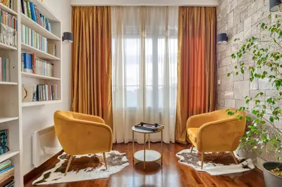 a living room with two chairs and a window at Ivanovic residences in Budva