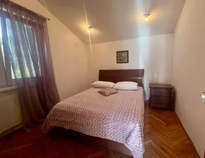 a bedroom with a bed and a window at Blue Sky Villa in Brca