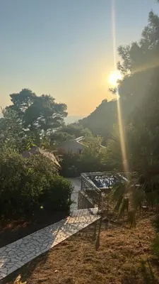 a sun shining over a river with a bridge at Blue Sky Villa in Brca