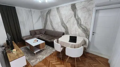 a living room with a couch and a table at City Center Relax Podgorica in Podgorica