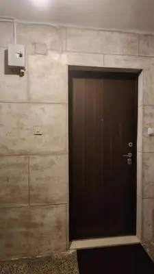 a black door in a room with a wall at City Center Relax Podgorica in Podgorica