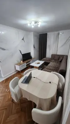 a living room with a table and a couch at City Center Relax Podgorica in Podgorica