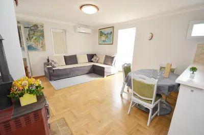 a living room with a table and a couch at Sunny apartment Tara in Kotor
