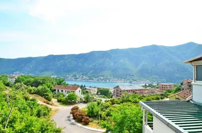 a view of a town with a lake and mountains at Sunny apartment Tara in Kotor