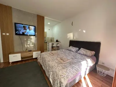 a bedroom with a bed and a flat screen tv at Apartment Simona in Budva