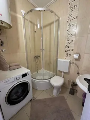 a bathroom with a shower and a washing machine at Apartment Simona in Budva
