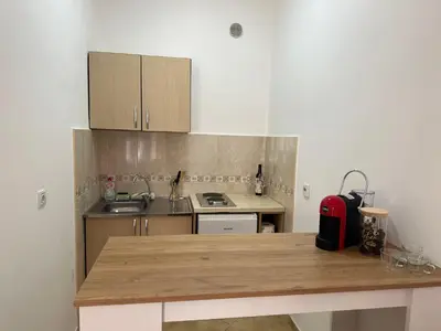 a small kitchen with a wooden counter top at Apartment Simona in Budva