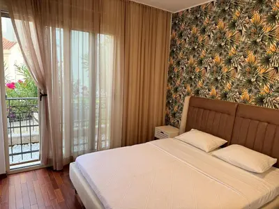 a bedroom with a bed and a large window at Viola Di Mare Apartments in Budva