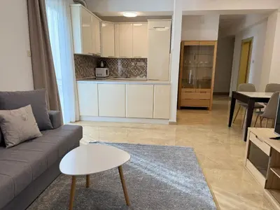 a living room with a couch and a kitchen at Viola Di Mare Apartments in Budva
