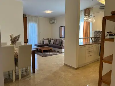 a kitchen and living room with a couch and a table at Viola Di Mare Apartments in Budva