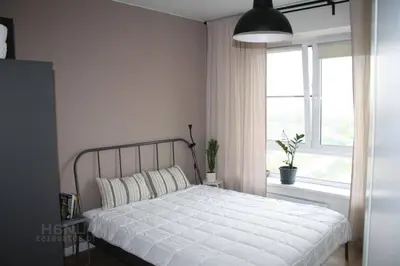 a bedroom with a white bed and a window at cozy family apartment in Cetinje