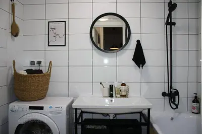 a bathroom with a sink and a washing machine at cozy family apartment in Cetinje