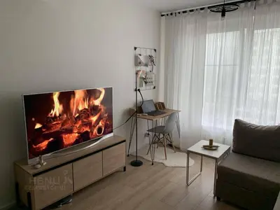 a living room with a fire in the fireplace at cozy family apartment in Cetinje