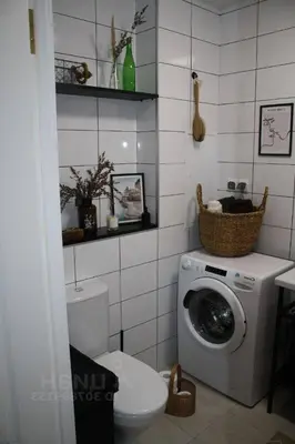 a bathroom with a washing machine and a toilet at cozy family apartment in Cetinje