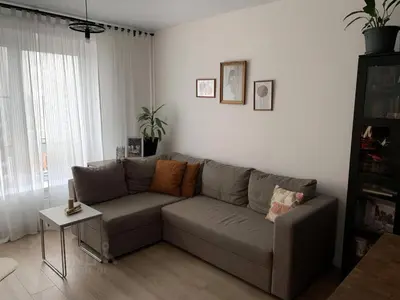 a living room with a couch and a table at cozy family apartment in Cetinje