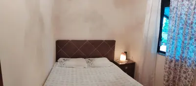 a small bed in a room with a window at Vrsutska 81 in Sutomore