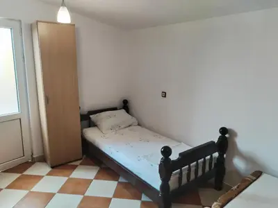 a small bedroom with a bed in a room at Vrsutska 81 in Sutomore
