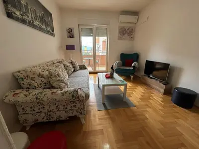a living room with a couch and a table at Apartman 38 in Podgorica