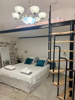 a bedroom with a bunk bed and a chandelier at Casa Behar in Kotor