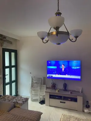 a living room with a flat screen tv on a wall at Casa Behar in Kotor