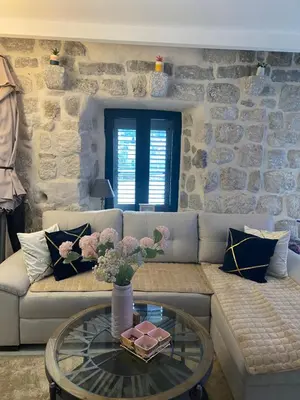 a living room with a couch and a glass table at Casa Behar in Kotor