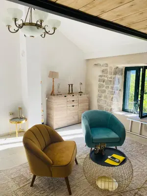 a living room with two chairs and a table at Casa Behar in Kotor