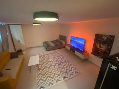 a living room with a couch and a flat screen tv at Podgorica 23 in Podgorica