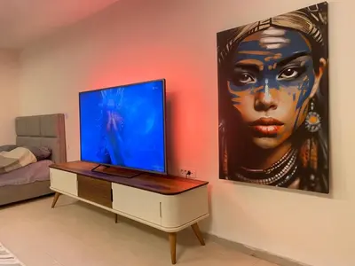 a living room with a painting of a woman on the wall at Podgorica 23 in Podgorica