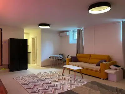 a living room with a couch and a table at Podgorica 23 in Podgorica