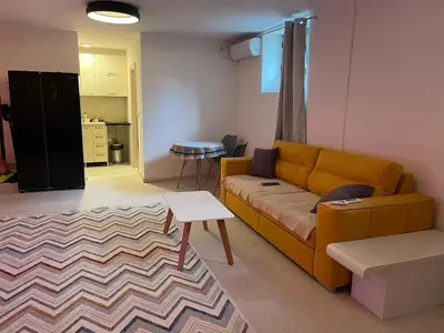 a living room with a couch and a table at Podgorica 23 in Podgorica